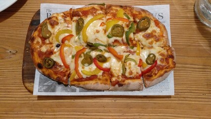 flatbread Pizza with Mozzarella cheese, Tomatoes, pepper, Spices and Fresh Basil. Italian pizza. Pizza Margherita