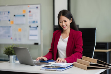 Business woman working at office with laptop and documents on desk, financial adviser analyzing data.