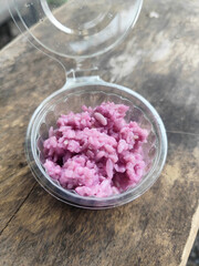 Sticky rice also known as sticky rice ribbon packed in plastic cups on bamboo table mats.