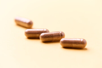 Carnitine capsules. Concept for a healthy dietary supplementation. Bright paper background. Soft focus. Close up.