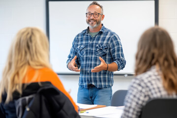 Instructor leading an engaging workshop with attentive participants in a small classroom
