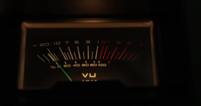 Analog VU meters on classic hi-fi reel-to-reel tape recorder. Retro sound level meter decibel meter in studio, vintage audio equipment.