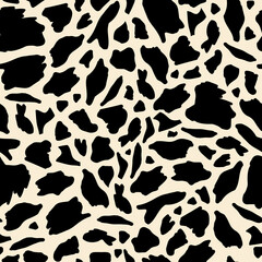seamless pattern features black and white irregular spots resembling a cowhide, creating a natural and organic design perfect for textiles, wallpapers, and decorative purposes