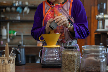 Process drip coffee, Barista start chose coffee bean and Roasting. Barista making drip coffee by pouring spills hot water on coffee ground with prepare filter from copper pot to glass transparent drip
