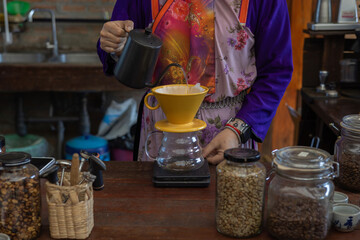 Process drip coffee, Barista start chose coffee bean and Roasting. Barista making drip coffee by pouring spills hot water on coffee ground with prepare filter from copper pot to glass transparent drip