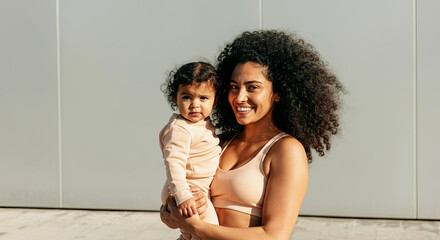 Heartwarming moment of a joyful mother holding her adorable baby.