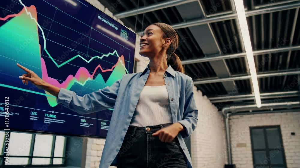 Poster business professional analyzing financial data on a screen in a modern office environment