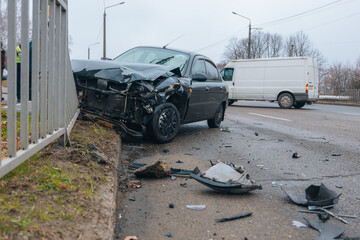 Broken bumper and hood of a car as a result of a collision with a pole. The car crashed into a lamp...