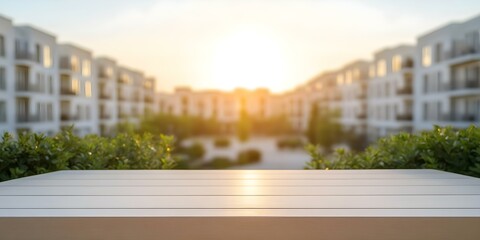 A sunlit scene with a blurred view of apartment buildings and greenery, focusing on a wooden table in the foreground. Concept Urban Landscape, Blurred Background, Wooden Table, Sunlit Scene