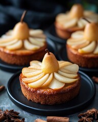 A delicious pear tart with beautifully arranged pear slices, set on a dark plate against a moody backdrop.