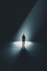 Silhouette of a Person Standing Alone in a Dark Space with Light