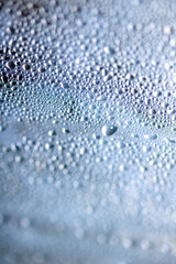Close Up of Condensation  Water Liquid Bubbles and Drips on Glass from Rain Abstract Background