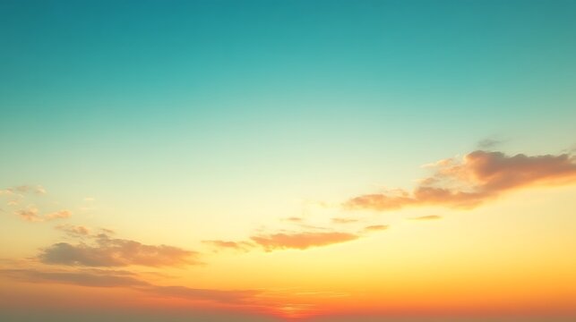 Serene sunset sky with orange and teal hues.