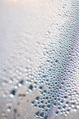 Close Up of Condensation  Water Liquid Bubbles and Drips on Glass from Rain Abstract Background