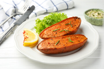 Tasty baked sweet potato served on white wooden table, closeup