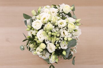 Beautiful wedding bouquet on light background, top view