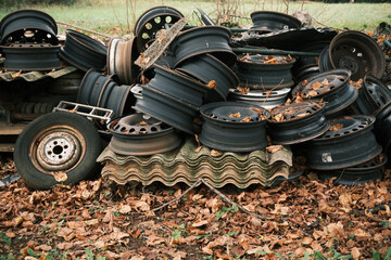 A sad mountain of old rusty wheel rims