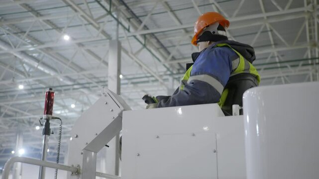 A Worker Diligently Operating a Zamboni Ice Resurfacer in a Contemporary Facility Setting. Clip