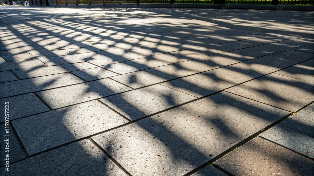 Poster Low angle perspective of sunlight casting intricate shadows on the surface of the concrete pavers creating a dynamic interplay of light and dark that enhances the depth of the