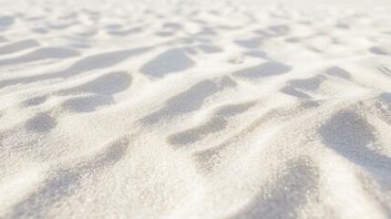 Fototapeta premium Textured White Sand Background Close-Up of Beach Sand with Light and Shadow Patterns.