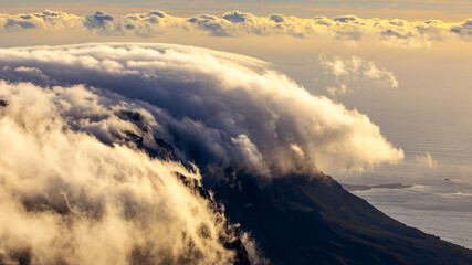 Fototapeta premium Beautiful view at sunset to the cloudy mountains from Table Mountain in Cape Town in South Africa