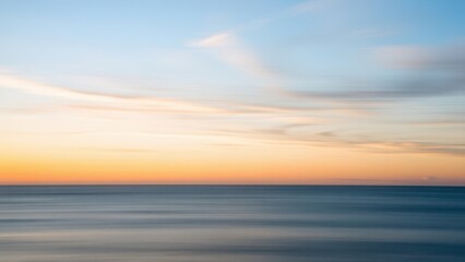 arafed view of a beach with a body of water and a sky