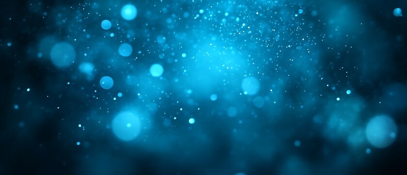 Abstract blue bokeh background with glowing particles.