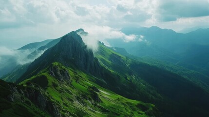 Fototapeta premium Majestic Mountain Range with Clouds and Lush Green Slopes Panoramic Landscape Photography
