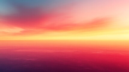 Fototapeta premium Vibrant sunset colors over a hazy horizon.