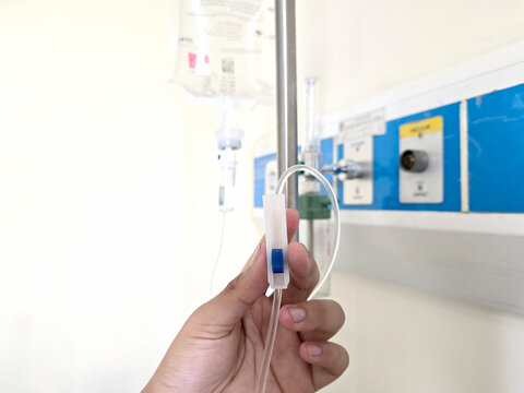 Nurse Hand Controlling IV Drip Rate