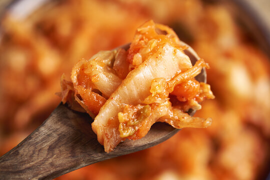 Fermented kim chi on a wooden spoon