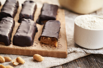 Homemade healthy chocolate bars made of whey protein powder and peanut butter