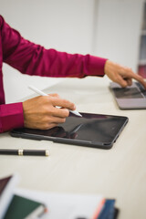 A focused man works diligently in his office, reviewing numerous accounting documents on his desk. His goal is to ensure accuracy and precision, avoiding errors in critical financial data.