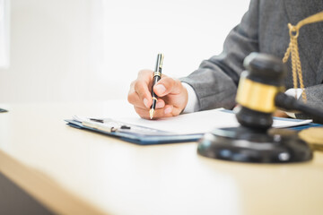 Male lawyer diligently examines documents placed on his desk, demonstrating his professionalism and dedication to finding legal truth, analyzing ideas, and pursuing justice with relentless focus.