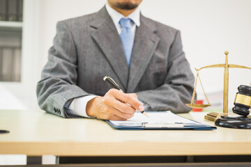 Male lawyer diligently examines documents placed on his desk, demonstrating his professionalism and dedication to finding legal truth, analyzing ideas, and pursuing justice with relentless focus.