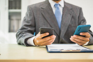 Male lawyer diligently examines documents placed on his desk, demonstrating his professionalism and dedication to finding legal truth, analyzing ideas, and pursuing justice with relentless focus.