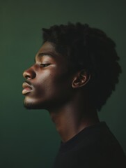 Fototapeta premium Thoughtful Young African American Man Profile Portrait, Glitter, Green Background, Close-up Studio Shot