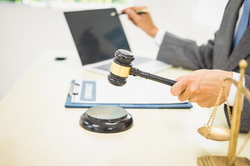 Male lawyer diligently examines documents placed on his desk, demonstrating his professionalism and dedication to finding legal truth, analyzing ideas, and pursuing justice with relentless focus.