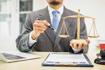 Male lawyer diligently examines documents placed on his desk, demonstrating his professionalism and dedication to finding legal truth, analyzing ideas, and pursuing justice with relentless focus.