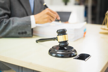 Male lawyer diligently examines documents placed on his desk, demonstrating his professionalism and dedication to finding legal truth, analyzing ideas, and pursuing justice with relentless focus.