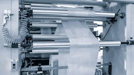 The operation of automatic plastic bag production machine. Close-up of the roller of the...