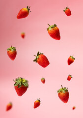 Floating ripe strawberries against a soft pink background, creating a dynamic and vibrant food photography composition. Perfect for healthy eating, summer vibes, and organic produce concepts.