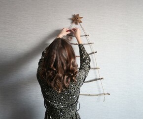girl decorating for christmas. christmas new year decorations, homemade tree