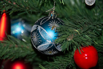 New Year's blue ball with silver sparkles on the Christmas tree