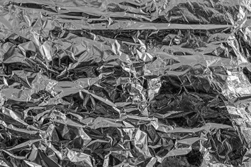 a sheet of silver leaf, foil with a shiny uneven surface. background for design and creativity