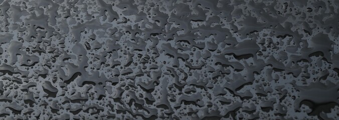 Water drops on grey glass surface, closeup