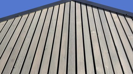 Plank wall turning into a pediment of vertical slats, panorama upwards, low angle of view - Powered by Adobe