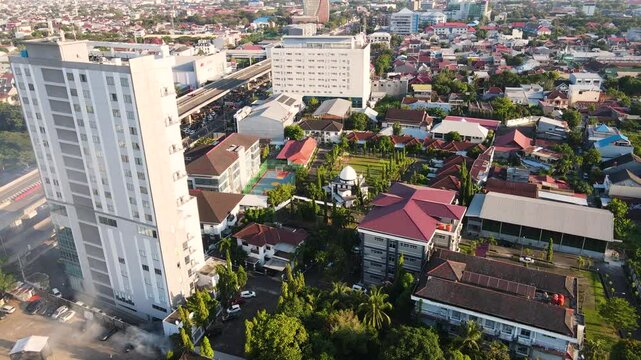 A Panoramic View of the Island Cityscape Bathed in Sunlight in Sulawesi, Indonesia - Aerial Drone Shot