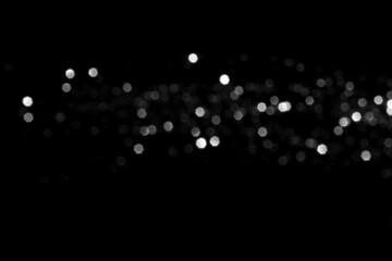White gray blurred bokeh lights on black background. Glitter sparkle stars for celebrate. Overlay for your design