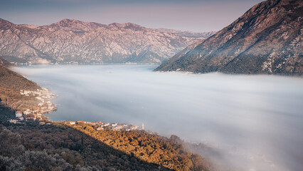 Scenic view of fog rolling over the Bay of Kotor in Montenegro, Europe, at sunrise